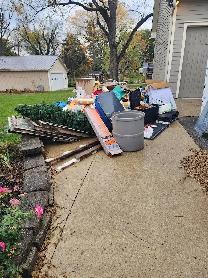 Dumpster being loaded with debris for Commercial Dumpster Rental in Lakewood